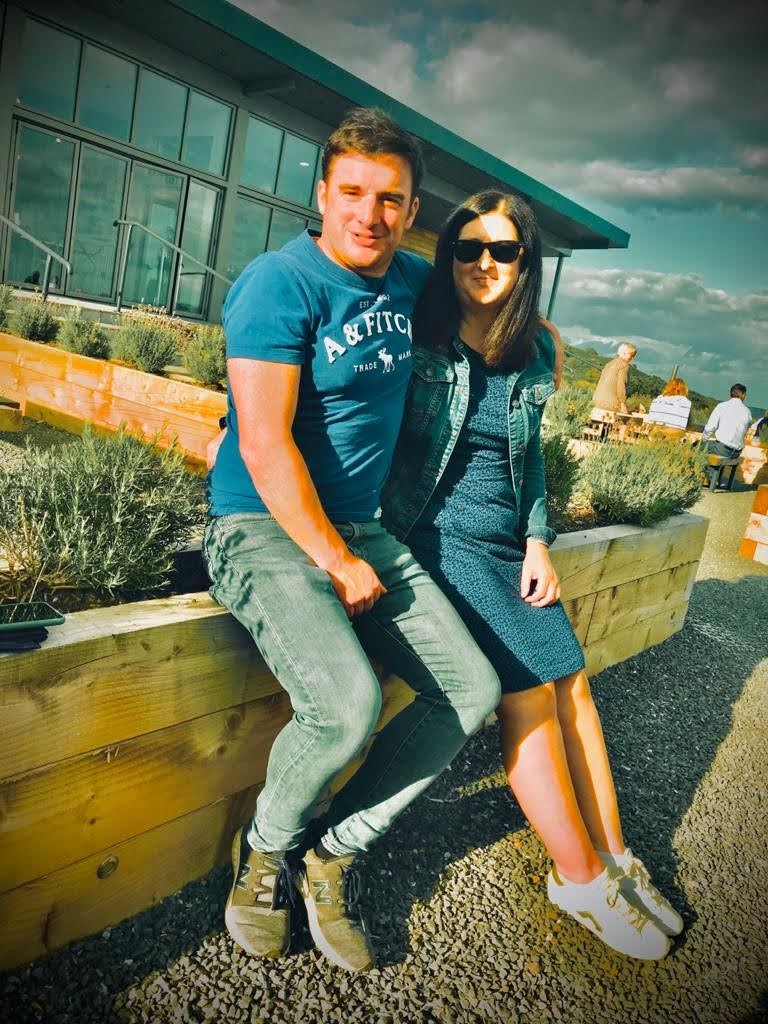 James and Lottie from Gatehouse Luxury Lodges sitting outside one of their hand-built lodges in Gatehouse of Fleet, Scotland.