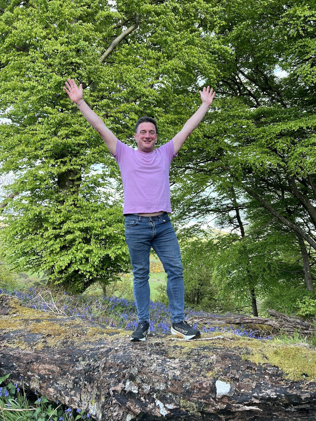 Standing on a fallen log surrounded by bluebells in Carstramon Wood near Gatehouse of Fleet