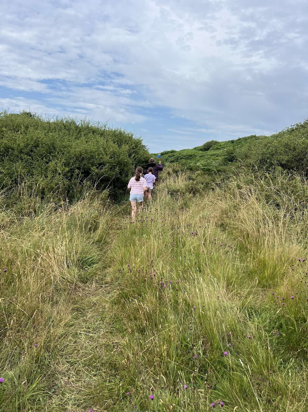 Kids climbing up from the beach onto Ardwall Isle